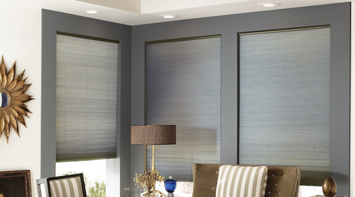 Gray cellular shades in a window